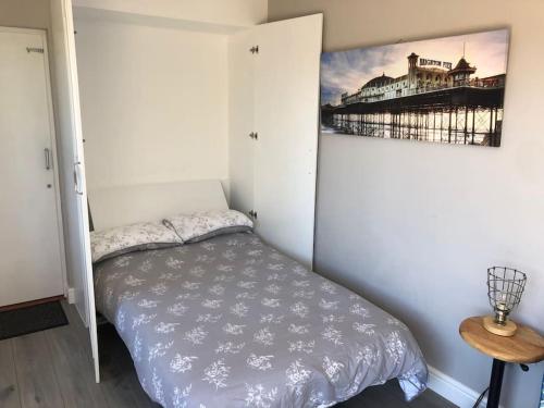 a bedroom with a bed and a picture on the wall at Spectacular Views, Great Location, Friendly in Brighton & Hove