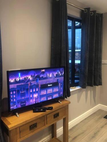 a flat screen tv sitting on top of a wooden table at Spectacular Views, Great Location, Friendly in Brighton & Hove