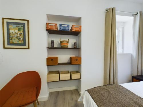 a bedroom with a bed and some shelves at Hidden Gem Hideaway Retreat in Central Town Area with AC in Gibraltar