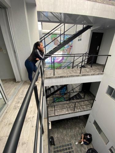 a man standing on a staircase in a building at Las Aguas Inner Experience in Bogotá