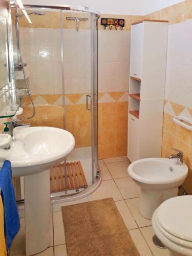 a bathroom with a shower and a sink and a toilet at FronteMare in San Cataldo