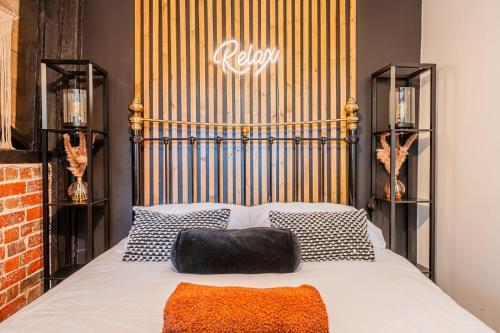 a bedroom with a bed with a metal head board at New Forest Cottage with Hot Tub, Fireplace and Private Garden in Cadnam
