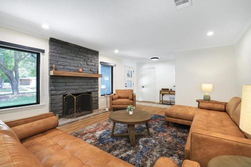 a living room with a couch and a fireplace at Pool Home Nr DT River Walk Alamo WiFi Yard in San Antonio