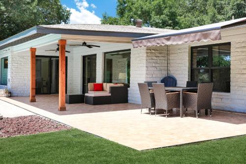 a patio with a table and chairs on it at Pool Home Nr DT River Walk Alamo WiFi Yard in San Antonio
