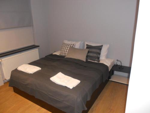 a bedroom with a bed with two towels on it at REK Inn in Reykjavík