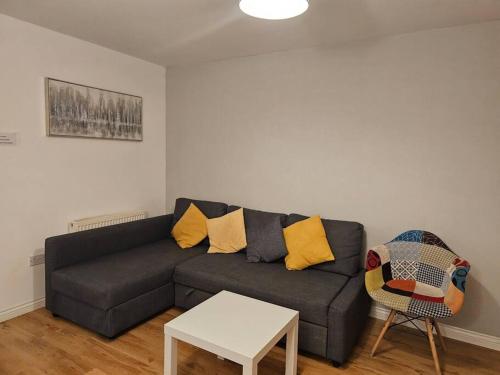 a living room with a couch and a table at The Park view, 2 Bedroom House in Kirkcaldy