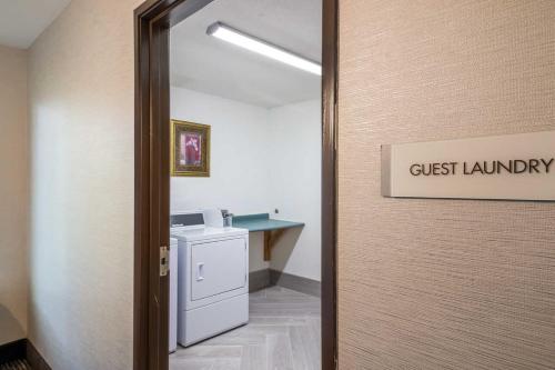a door to a bathroom with ajust laundry sign on it at Quality Inn near MCAS Cherry Point in Havelock