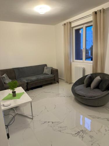 a living room with a couch and a table at Don Angelo in Le Blanc-Mesnil