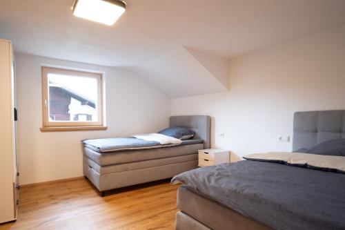 a bedroom with two beds and a window at Chalet Hildegard in Pfronten