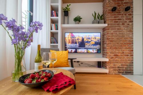 a living room with a bowl of fruit on a table at Studio Olesińska in Warsaw