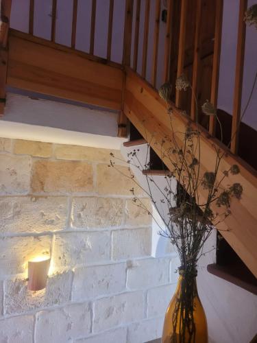 a vase with flowers in it sitting under a staircase at My Rooms Ciutadella Adults Only by My Rooms Hotels TI in Ciutadella