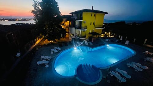 a large swimming pool in front of a building at Private Apartment with Sea View in Sozopol