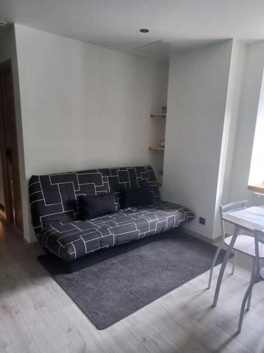 un lit dans une chambre avec un canapé dans le coin dans l'établissement Chez Ange, à Saint-Étienne-de-Cuines