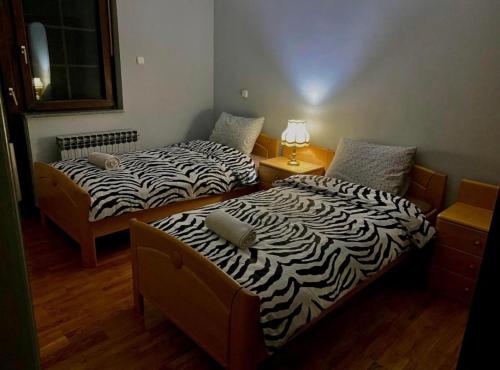 two beds sitting next to each other in a room at Villa Tara in Feratovo Polje