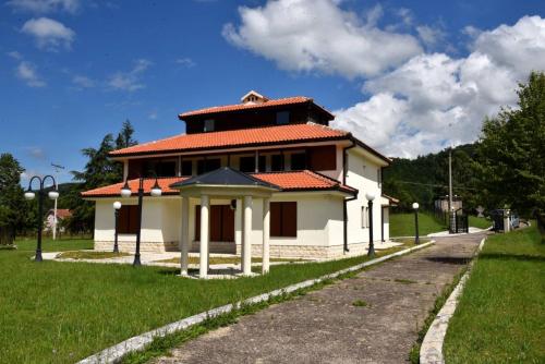 a small white house with a red roof at Villa Tara in Feratovo Polje