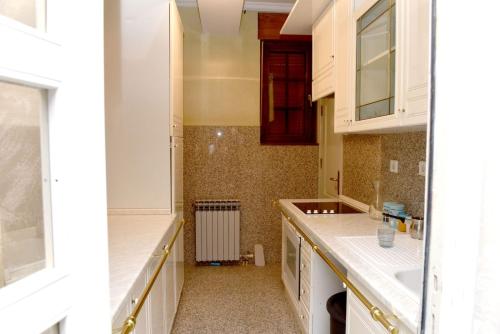 a kitchen with white cabinets and a sink at Villa Tara in Feratovo Polje
