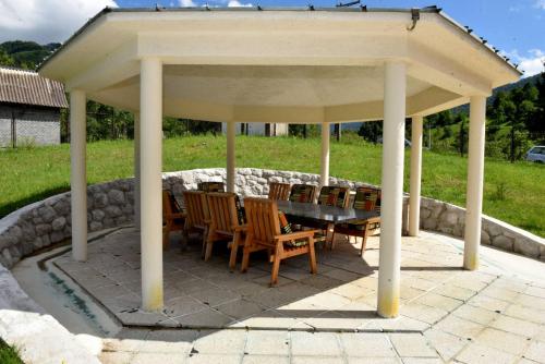 a pavilion with a table and chairs on a patio at Villa Tara in Feratovo Polje