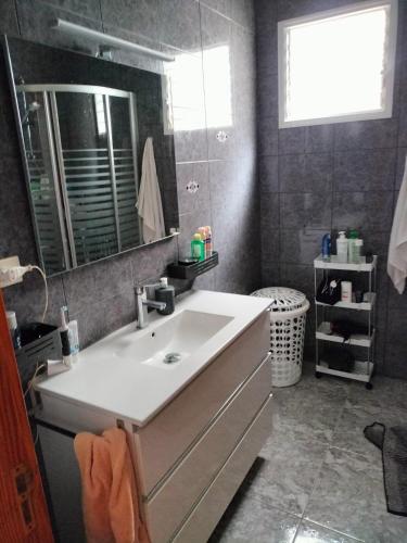 a bathroom with a sink and a mirror at Casa Esperanza in Arinaga