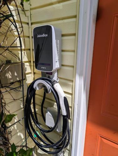 a television and a hose attached to a house at French Island Whot Tub, Kayak, Lake View, Ev in La Crosse