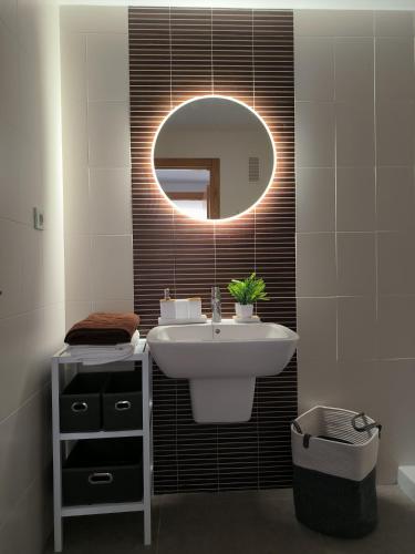 a bathroom with a sink and a mirror at Apartamento Los Portales La Manga Spa & Gym in La Manga del Mar Menor