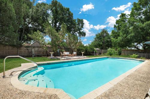 a swimming pool in a yard with a fence at Pool Home Nr DT River Walk Alamo WiFi Yard in San Antonio