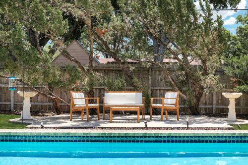 a table and chairs next to a swimming pool at Pool Home Nr DT River Walk Alamo WiFi Yard in San Antonio