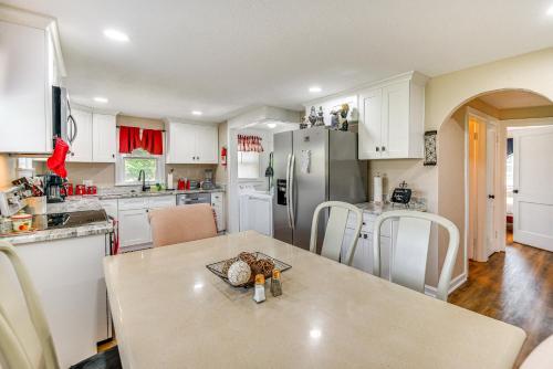 a kitchen with white cabinets and a table at Modern Cape Charles Home 1 Mi to Kiptopeke Beach! in Cape Charles