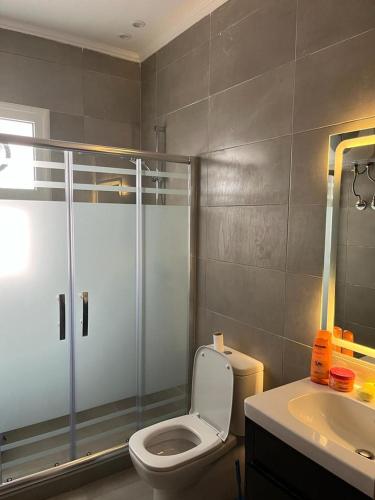 a bathroom with a shower and a toilet and a sink at 3bedroom chalet double view in AMWAJ in El Alamein