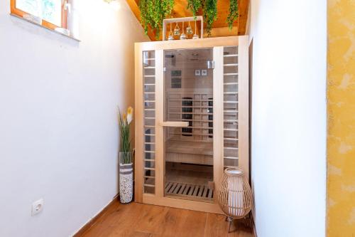 a room with a glass door in a hallway at Villa Kiara in Unešić