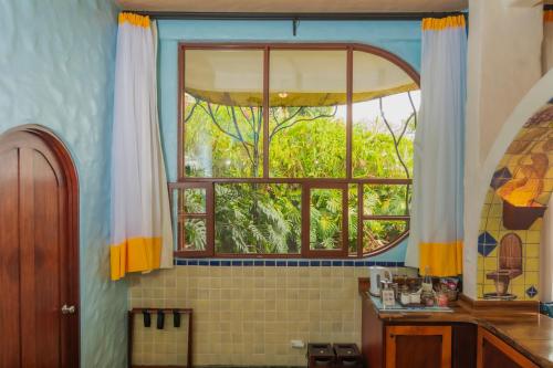 a bathroom with a large window in a room at Finca Rosa Blanca Coffee Farm and Inn in Heredia