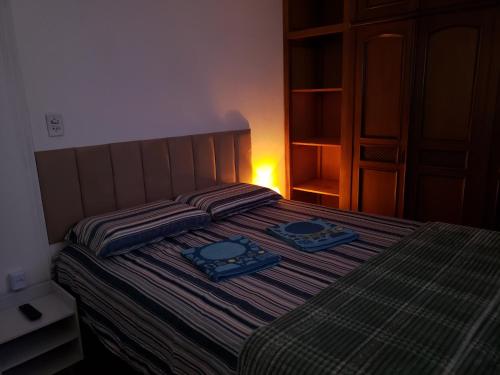 a bedroom with a bed with two blue dishes on it at Pousada Monte Gerizim in Sao Paulo