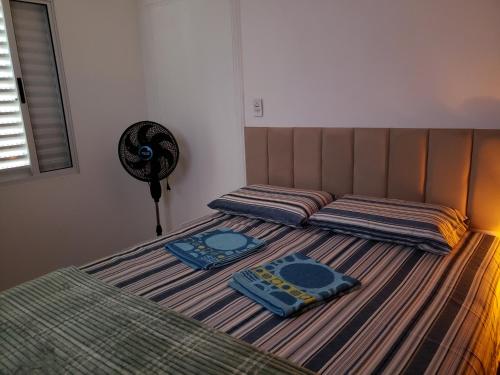 two twin beds in a bedroom with a fan at Pousada Monte Gerizim in Sao Paulo