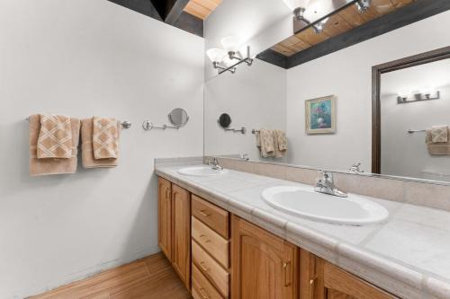 a bathroom with a sink and a mirror at Corwin's Quarters in Kings Beach