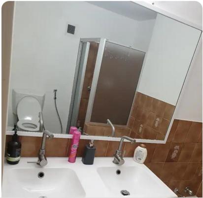 a bathroom with a sink with a mirror and a sink at Dana-Private Room in 3-Bedroom Apartment-1 in Canberra