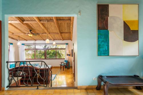 a room with a bed and a painting on the wall at Finca Rosa Blanca Coffee Farm and Inn in Heredia