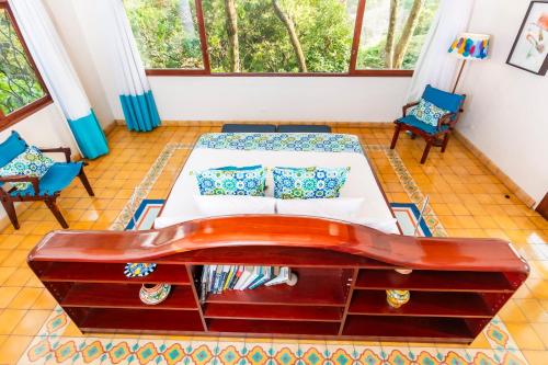a bedroom with a bed and a large window at Finca Rosa Blanca Coffee Farm and Inn in Heredia