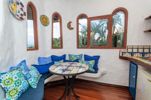 a room with blue chairs and a table at Finca Rosa Blanca Coffee Farm and Inn in Heredia