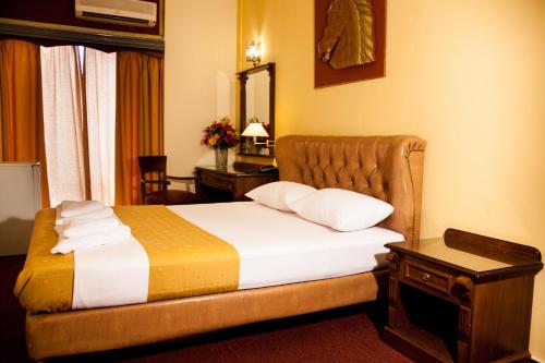 a hotel room with a bed and a mirror at Galini Palace in Athens