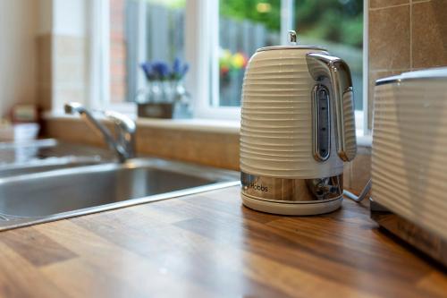 a toaster sitting on a kitchen counter next to a sink at Riverside Townhouse Antrim in Antrim