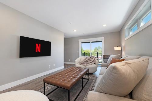 a living room with a n on the wall at The Birches in Lake Leelanau