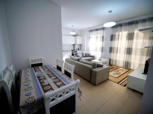 a living room with a couch and a table in a room at Eras Apartament in Shkodër