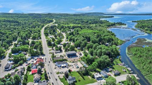 an aerial view of a town next to a river at The Birches in Lake Leelanau