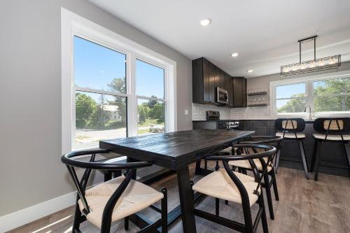 a kitchen with a black table and chairs at The Birches in Lake Leelanau