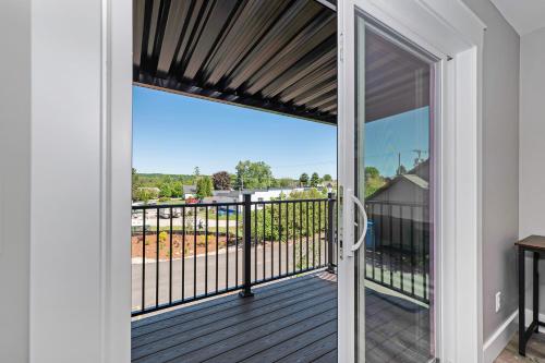 a door leading to a balcony with a view at The Birches in Lake Leelanau