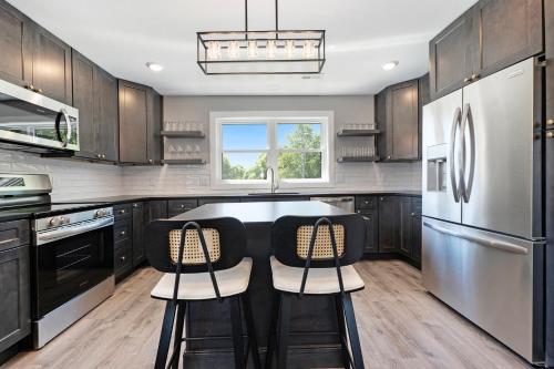 a kitchen with black cabinets and a kitchen island at The Birches in Lake Leelanau