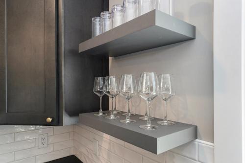 a row of wine glasses sitting on a shelf at The Birches in Lake Leelanau