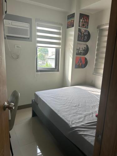 a bedroom with a bed and a window at Paranaque Manila Bloom residences in Manila