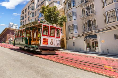 a trolley car on a city street with buildings at Powell Place in San Francisco