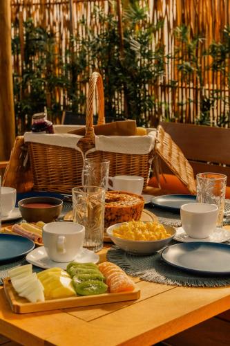 a wooden table with food on top of it at Pousada Casa Buriti - Atins in Atins