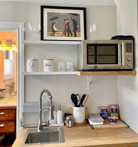 a kitchen counter with a microwave and a sink at Beautiful Modern In-town Studio with Kitchenette in Telluride